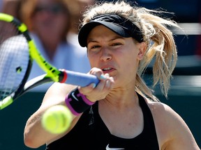 Canada's Eugenie Bouchard returns a shot to Alexandra Dulgheru, from Romania, during their tennis match at the Volvo Car Open in Charleston, S.C., Tuesday, April 5, 2016. (AP Photo/Mic Smith)