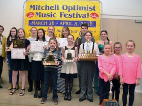 Mitchell Music Festival award winners gathered for a group picture with Betty Harley, the wife of festival founder the late Ern Harley, under the festival banner after the Concert of Stars had concluded April 8. Front row, from left: Ava Hill, Sarah Olsen, Bryce Otten, Lauren McKay, Maddox Keller, Brooklyn Boville, Josie Smith and Gabrielle McArthur. Back row, from left: Betty Harley, Josie Nicholson, Sarah Kolkman, Mary Kolkman, Hannah Burgsma, Sam McEwan and Elysse Delaney. GALEN SIMMONS MITCHELL ADVOCATE