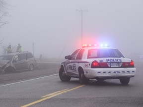 Police investigate the scene of a two-vehicle collision at the intersection of Wonderland Road South and Glanworth Drive in London, Ont. on Monday April 11, 2016. The driver of a Honda SUV failed to adjust their driving to account for heavy fog, say police, after they ran a stop sign on Wonderland Road, striking a Honda minivan travelling on Glanworth Drive around 8:30 a.m. Monday.  Both drivers, the only occupants on the two vehicles involved, were taken to hospital, one with serious but non-life-threatening injuries.  The force of the crash caused the SUV to come to rest on the front yard of an adjacent home, the minivan coming to rest at the side of Glanworth Drive.  Police are investigating the incident to determine if charges will be laid.  Craig Glover/The London Free Press/Postmedia Network