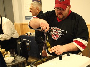 Seaforth Ward Coun. Nathan Marshall pours some soup at the Souper Saturday April 9. (Shaun Gregory/Huron Expositor)