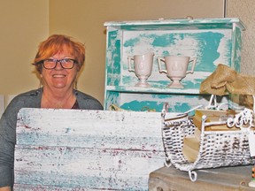 Louise Berg with refinished items at the Home Party Expo held April 1 and 2.