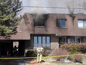 Kingston Fire and Rescue put out flare-ups from a house fire that occurred Saturday morning at 4243 Bath Rd. (Steph Crosier/The Whig-Standard)