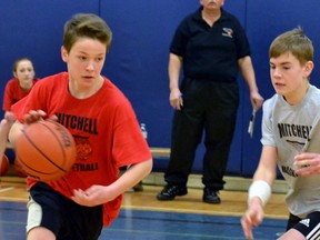 Carter Yost of the senior Raptors tries to get past senior Spurs defender Kurtis Visser during the final Mitchell Minor Basketball night of the season at Mitchell District High School April 6. Visser and the Spurs went on to win the senior title. GALEN SIMMONS MITCHELL ADVOCATE