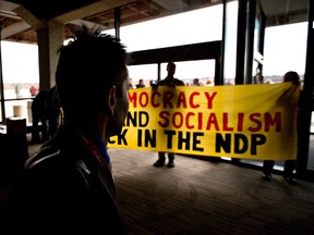 NDP delegates show a banner during the 2016 NDP Federal Convention in Edmonton Alta, on Sunday, April 10, 2016. THE CANADIAN PRESS/Jason Franson