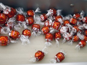 Lindor chocolates are seen on a conveyor during production at the plant of Swiss chocolate maker Lindt & Sprungli in Kilchberg, Switzerland, in this file picture taken September 24, 2015. REUTERS/Arnd Wiegmann