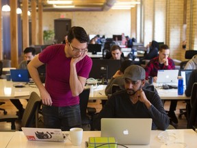 A tutor helps a student at Lighthouse Labs which offers bootcamps on coding in Toronto.
