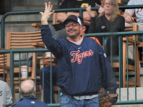 Bill Dugan of Roseville, Mich., shows that he caught five foul balls during the Detroit Tigerss Pittsburgh Pirates at Comerica Park in Detroit on Monday,  April 11, 2016. (Robin Buckson/Detroit News via AP)
