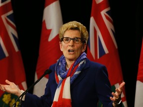 Premier Kathleen Wynne speaks to the media at Queen's Park in Toronto Monday, April 11, 2016. (Stan Behal/Toronto Sun)