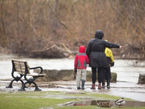 Amanda Lynn Stubley took her sons Oliver, 7, and Jacob, 10 Horak to see the high and fast flowing north branch of the Thames River in Gibbons Park in London, Ont. on Monday March 28, 2016. (MIKE HENSEN, The London Free Press)