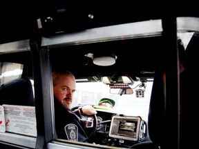 Const. Rick Carr of the Greater Sudbury Police Service traffic management unit demonstrates the service's new in car camera system in Sudbury, Ont., on Monday April 11, 2016. Gino Donato/Sudbury Star/Postmedia Network