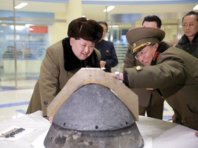 North Korean leader Kim Jong Un looks at a rocket warhead tip after a simulated test of atmospheric re-entry of a ballistic missile, at an unidentified location in this undated file photo released by North Korea's Korean Central News Agency (KCNA) in Pyongyang on March 15, 2016. (REUTERS/KCNA/Files)