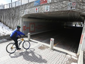 Cyclists and pedestrians share a tunnel going under the Campus transit station at Ottawa University, April 12, 2016.