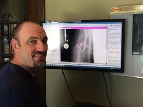 Dr. PJ Rocheleau shows an X-ray of a nine-month-old puppy named Jasmine who will undergo hip replacement surgery at the Espanola Animal Hospital.