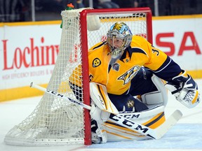 Nashville Predators goalie Pekka Rinne watches the puck in the corner during second-period NHL action against the Vancouver Canucks at Bridgestone Arena in Nashville on March 24, 2016. (Christopher Hanewinckel/USA TODAY Sports)