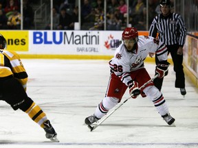 Niagara IceDogs forward Josh Ho-Sang tries to make his way around Kingston Frontenacs defenceman Roland McKeown during Game 1 of an Ontario Hockey League Eastern Conference semifinal series at the Rogers K-Rock Centre on Friday. (Steph Crosier/The Whig-Standard)