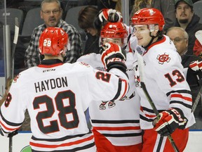 Niagara IceDogs Aaron Haydon and Graham Knott (13) congratulate Vince Dunn on scoring the first goal of the game against the Kingston Frontenacs during Game 1 of an Ontario Hockey League playoff series at the Rogers K-Rock Centre on Thursday. (Julia McKay/The Whig-Standard)