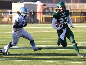 Hard-running St. Joseph Celtics slotback Zach Woodman evades a Paul Kane Blues tackler in last year’s Tier-Two high school playoff that ended in a 33-9 victory for the Grande Prairie representatives on their home turf. The keen rivalry continued through trials for the North team that will soon start to prepare for the annual North-South classic May 23. (Logan Clow)