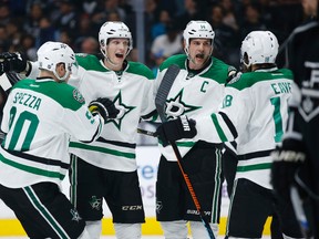 In this April 2, 2016, file photo, Dallas Stars left wing Jamie Benn, second from right, celebrates with teammates, from left to right, Jason Spezza, John Klingberg and Patrick Eaves during an NHL game against the Los Angeles Kings. The Stars are the best bet in the Western Conference to win the Stanley Cup. (AP Photo/Danny Moloshok, File)