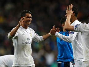 Real Madrid's Cristiano Ronaldo celebrates with team mates at the end of the Champions League 2nd leg quarterfinal soccer match between Real Madrid and VfL Wolfsburg at the Santiago Bernabeu stadium in Madrid, Spain, Tuesday April 12, 2016. (AP Photo/Francisco Seco)