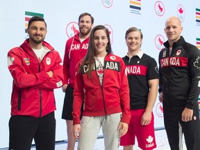 Olympic team members fencerJoseph Polossifakis, left to right, wrestler Korey Jarvis, swimmer Aurelie Rivard, cyclist Hugo Barrette and paddler Ben Russell model some of the Canadian Olympic team clothing for media on Tuesday April 12, 2016.THE CANADIAN PRESS/Frank Gunn