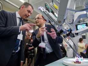 Dr. Bob Kiaii, the chair/chief of cardiac surgery at LHSC (right) explains how two tiny cameras are included on one arm of the da Vinci surgical robots to allow 3-D vision of the surgical field to Jamie Crich, President, Auburn Developments & Auburn Homes.
The Crich family on Tuesday April 12, 2016 donated $1 million to the London Health Sciences Foundation for the CSTAR program (Canadian Surgical Technologies & Advanced Robotics). (MIKE HENSEN, The London Free Press)