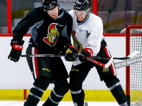 Senators defenceman Dion Phaneuf (left) battles with teammate Ryan Dzingel (right) during practice at the Canadian Tire Centre on March 14, 2016. (Errol McGihon/Ottawa Sun)