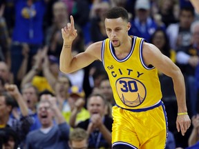 Golden State Warriors guard Stephen Curry celebrates after scoring against the Washington Wizards during an NBA game Tuesday March 29, 2016, in Oakland, Calif. (AP Photo/Marcio Jose Sanchez)