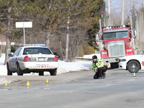 Gino Donato/Sudbury Star
Const. Richard Bilcik of the Greater Sudbury Police traffic management unit investigates the scene where an 11-year-old boy was struck by a vehicle on Municipal Road 15 on Tuesday.