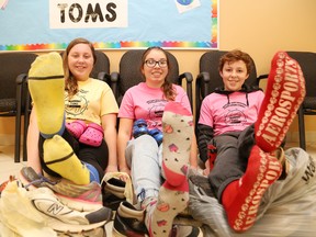 Alyssa Belanger, 13, left, Chelsey Pilon, 13, and Kyle Beaulieu, 13, participate in Ecole Ste-Marie's One Day Without Shoes Day at the Azilda, Ont. school on Tuesday April 12, 2016. Students and staff went shoeless for the day to better understand what many people in developing countries have to deal with because they can't afford shoes. In an effort to make a difference, staff and students are collecting shoes until April 22. The items will be donated to Soles 4 Souls, as well as a local organization to be determined later. John Lappa/Sudbury Star/Postmedia Network