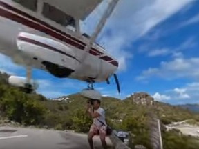 A tourist in St. Barts nearly loses his head while taking photos of an incoming small plane. (YouTube/Screengrab)