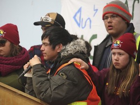 A girl places her hand on the shoulder of a speaker to lend support, as youths from three First Nations communities make a presentation after a march on April 7, 2016 in support of efforts to tackle a sharp rise in suicide rates in Attawapiskat, Ont., in this picture provided by Jackie Hookimaw-Witt. (REUTERS/Jackie Hookimaw-Witt/Handout via Reuters)