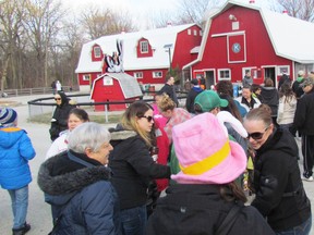 Families are shown in this file photo lining up for train rides at the Children's Animal Farm in Canatara Park during this year's Easter in the Park. The popular animal farm recently received a $3,860 donation, raised by Sarnia mother Chloe Dennis during a second annual online auction she organized. (File photo/Sarnia Observer/Postmedia Network)