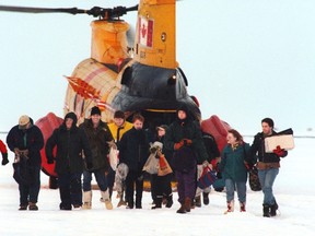 A group of fishermen disembark from a Canadian Armed Forces search and rescue chopper after being plucked from an ice floe on Lake Simcoe in this file photo.