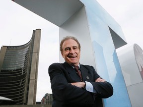 Councillor Norm Kelly with the TORONTO sign outside City Hall. (Sun file photo)