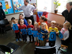 Emily Mountney-Lessard/The Intelligencer
Kids from one of the YMCA's programs help out at the launch of the 2016 Strong Kids campaign, held at the YMCA on Wednesday in Belleville. This year's campaign goal is $150,000. Also shown are Jamie Troke (white shirt), this year's volunteer chairman, and Dave Allen (left) acting president and CEO, YMCA of Central East Ontario.