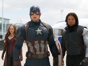 This image released by Disney shows Elizabeth Olsen, left, Chris Evans and Sebastian Stan in a scene from Marvel's "Captain America: Civil War," opening in theaters nationwide on May 6, 2016. (Disney/Marvel)