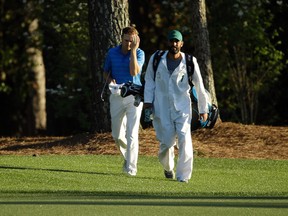 Jordan Spieth and Michael Greller react along the 18th hole during the final round of the 2016 The Masters golf tournament at Augusta National Golf Club. (Rob Schumacher/USA TODAY Sports)