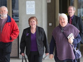 Joseph Wilson, left, is joined by fellow defendants Nancy McSloy, middle, and Jack McSloy, background, as they and an unidentified supporter leave the court house after their lawyers sought to have the $3.5 defamation case brought against them by Councillor Bill Armstrong thrown out in London, Ont. on Wednesday April 13, 2016. (CRAIG GLOVER, The London Free Press)