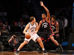Brooklyn Nets guard Bojan Bogdanovic drives against Toronto Raptors forward Bruno Caboclo during the first quarter at Barclays Center. (Anthony Gruppuso/USA TODAY Sports)