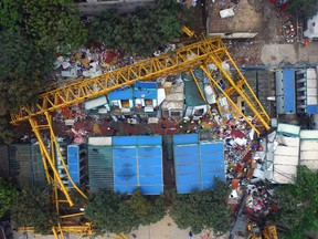 This photo released by China's Xinhua News Agency shows a collapsed temporary structure at an accident site in Dongguan City, south China's Guangdong Province, Wednesday, April 13, 2016. The 80-ton scaffold fell directly onto two-story temporary buildings at the construction site amid a fierce windstorm. (Liang Xu/Xinhua via AP)