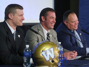 Blue Bombers coach Mike O’Shea (left), GM Kyle Walters (centre) and president/CEO Wade Miller interact with fans at the team’s fan forum Wednesday night