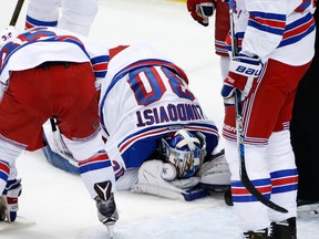 New York Rangers goalie Henrik Lundqvist kneels on the ice after getting a stick to the face during the first period of a first-round NHL playoff hockey game against the New York Rangers in Pittsburgh, Wednesday, April 13, 2016. Lundqvist left the game after the first period. (AP Photo/Gene J. Puskar)