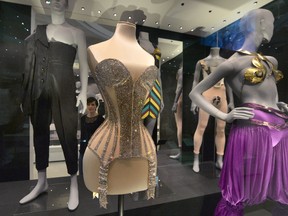 A woman views lingerie on display during the press preview of Undressed: A Brief History of Underwear at the Victoria and Albert museum, in London, Tuesday April 12, 2016. (Anthony Devlin/PA via AP)