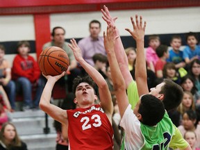 Nicholas Burke, left, of Northeastern Cougars, fires a shot over Fraser LaRocque, middle, and Noah Fader, of Princess Anne Panthers, at the Rainbow District School Board elementary school boys championship game at Northeastern Elementary School in Garson, Ont. on Wednesday April 13, 2016. The Cougars won 35-27. John Lappa/Sudbury Star/Postmedia Network