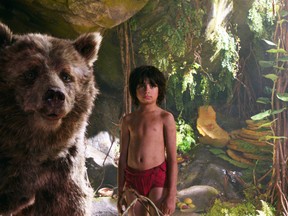 In this image released by Disney, Mowgli, portrayed by Neel Sethi, right, and Baloo the bear, voiced by Bill Murray, appear in a scene from, "The Jungle Book." (Disney photo)