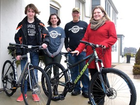 Two bikes were donated to deserving teens from donations made at the 3rd annual TillsonBURN 100-km road-and-trail ride on Good Friday, organized by Jeff Ward. From left are Dylan Taylor, with his new 'hybrid', TillsonBURN sponsor Outspokin Cycle's Tara Mott, Ward (who came up with Freedom Bikes for Teens), and Kierra Plunkett, with her new Raleigh mountain bike. (CHRIS ABBOTT/TILLSONBURG NEWS)