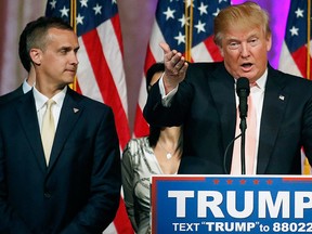 Campaign manager Corey Lewandowski (L) stands next to Republican U.S. presidential candidate Donald Trump  during a news conference in Palm Beach, Floa., in this file photo taken March 15, 2016.   REUTERS/Joe Skipper/Files