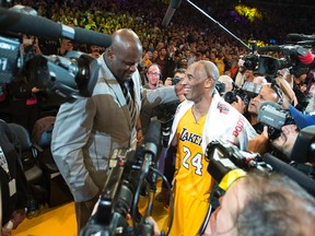 Los Angeles Lakers' forward Kobe Bryant is greeted by Shaquille O'Neal after an NBA basketball game against the Utah Jazz at Staples Center in Los Angeles on April 13, 2016. (Michael Goulding/The Orange County Register via AP)