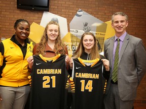 Cambrian Golden Sheild womens basketball coach Nambogga Sewali and Cambrian College president Bill Best welcome  Merrissa Moore and  Megan Desormeaux  to the 2016-17 team roster in Sudbury, Ont. on Wednesday April 13, 2016. Gino Donato/Sudbury Star/Postmedia Network