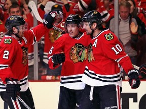 Duncan Keith and Patrick Sharp of the Chicago Blackhawks celebrate with Teuvo Teravainen after he scored a goal during second-period action against the Minnesota Wild in Game 1 of the Western Conference Semifinals at the United Center in Chicago on May 1, 2015. (Jonathan Daniel/Getty Images)